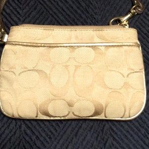 Coach tan and gold logo wristlet for women